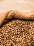 Green Unroasted Coffee Beans In Sack Stock Photo