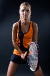 Beautiful Woman Playing Tennis Indoor. Isolated On Black Stock Photo