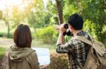 Couple Of Tourists Heading To The Forest With Maps In Hand Searc Stock Photo