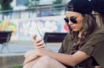 Beautiful Young Woman Using Her Mobile Phone In The Street Stock Photo