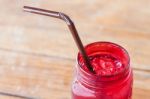 Iced Drink In Red Glass On Wooden Table Stock Photo