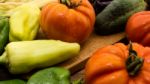 Several Vegetables On Wooden Chopping Board And Table Stock Photo