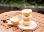 Mini Pies On Wooden Plate Stock Photo