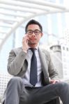 Asia Business Man Using A Mobile Phone Stock Photo