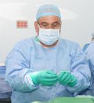 Doctor Preparing A Catheter For Insertion On A Patient. Slide Sa Stock Photo