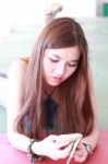 Portrait Of Thai Adult Beautiful Girl Using Her Smart Phone And Smile Stock Photo