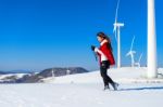 Young Woman Is A Happiness With Camera In Winter Of Sky And Winter Road With Snow And Red Dress Stock Photo