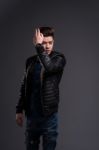 Casual Young Man In Black Leather Jacket And Denim Jeans Stock Photo