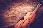 Violin On Grunge Dark Wood Background Stock Photo