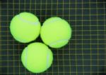 Three Tennis Balls On A Racket Stock Photo