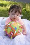 Infant Examining Ball Stock Photo