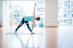 Asian Woman Doing Yoga Indoors Stock Photo