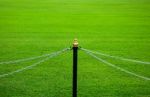 Fence Of Chain On Green Grass Stock Photo