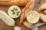 Baguette With Herb Butter And Rosemary Thyme On Rustic Wooden Background Stock Photo