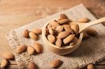 Almond In Wooden Spoon On Table Stock Photo