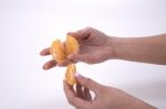 Woman Holding Slices Of Mandarin Stock Photo