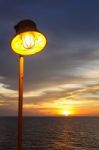 Lighting Of Warm Lamp And Lighting Of Sunset At Sea Stock Photo