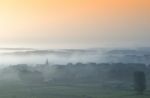 Village In The Morning Fog Stock Photo