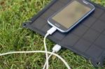 Mobile Phone Charging With Solar Energy - Charger Stock Photo