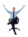 Sitting Businessman Arms Raised Stock Photo