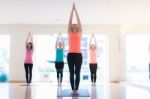 Asian Woman Doing Yoga Indoors Stock Photo