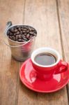 Red Cup Of Espresso On Wooden Table Stock Photo