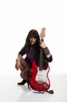 Young Beautiful Woman With Guitar In The Studio Stock Photo