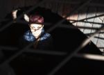 Punk Girl Sitting On The Floor Behind Metal Bars Stock Photo