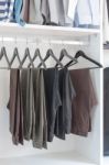 Pants Hanging On Rack In Wardrobe Stock Photo