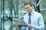 Handsome Businessman Reading A Newspaper Stock Photo