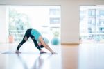 Asian Woman Doing Yoga Indoors Stock Photo