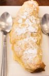 Delicious Almond Croissant Sprinkled With Icing Sugar Stock Photo