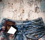 Blue Jeans With Cell Phone, Flashlight And Passport In A Pocket Stock Photo