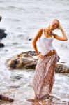 Beautiful Young Blonde Woman Posing Outdoor At The Rocky Sea Sho Stock Photo