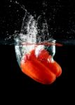 Sweet Pepper Drop Into Water Stock Photo