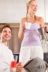 Couple In Kitchen Having Breakfast Stock Photo