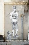 Painting Of Boy And Dog On A Wall In Venice Stock Photo