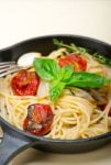 Spaghetti Pasta With Baked Cherry Tomatoes And Basil Stock Photo