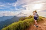 Hiker Teen Girl Holding A Camera For Photography Stock Photo