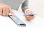 Woman Using Phone And Credit Card Shopping Online Stock Photo