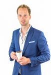 Young Salesman Promoting Coffee Beans In Cup Stock Photo