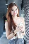 Portrait Of Thai Adult Beautiful Girl Using Her Smart Phone And Smile Stock Photo