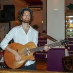 Folk Singer In A Restaurant In Berlin Stock Photo