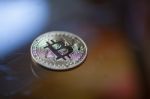 Bitcoin Curency Coin On Glass Table Stock Photo