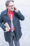 Young Businessman With A Newspaper With An Smartphone Stock Photo