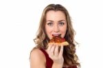 Young Female Having Yummy Pizza Slice Stock Photo