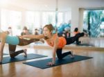 Asian Woman Doing Yoga Indoors Stock Photo