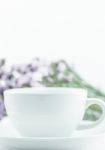 White Mug Cup And Static Flower Stock Photo