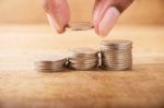 Vintage Close Up Of Hand Stacking Silver Coins Stock Photo