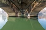 Under A Bridge With A River Stock Photo